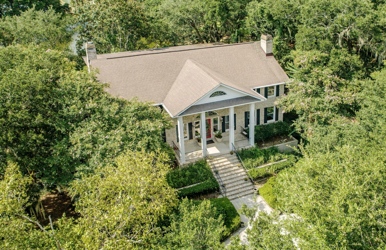 Classic brick traditional home at 1580 Aztec Lane surrounded by mature trees