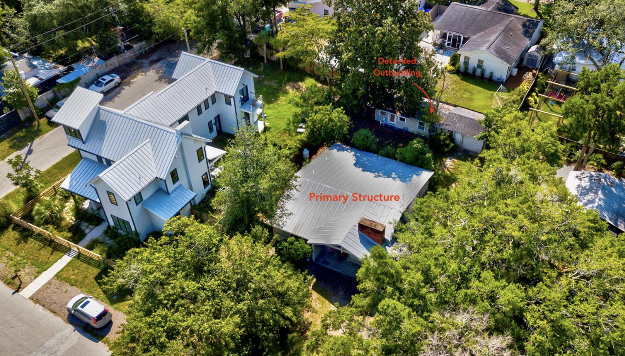 Aerial view of 637 Palmetto Street, a modern white farmhouse with detached outbuilding